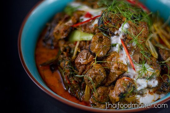 Swamp eel triple layered red curry with fingerroot, bitter ginger, sand ginger and Thai basil flowers แกงเผ็ดปลาไหลทรงเครื่อง