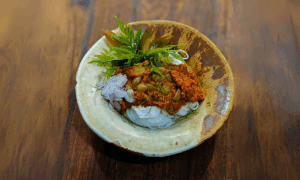 c1933 Gaaeng Khuaa Phrik Baang Chaang (แกงคั่วพริกบางช้าง) Thai kua curry served with khanom jeen fermented rice noodles topped with pickled garlic